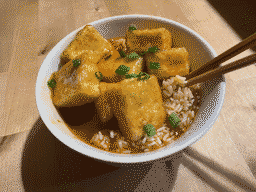 Luscious, shallow-fried tofu in a gooey & smooth sweet-and-spicy sauce served over rice & garnished with scallions.